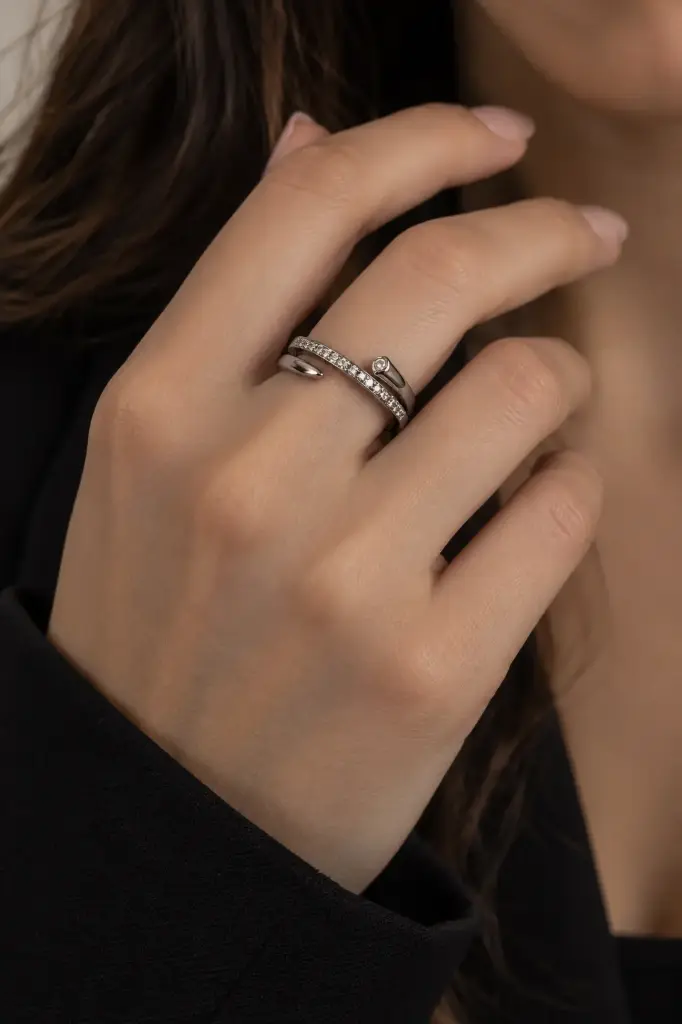 Elegant open silver ring with sparkling stones.