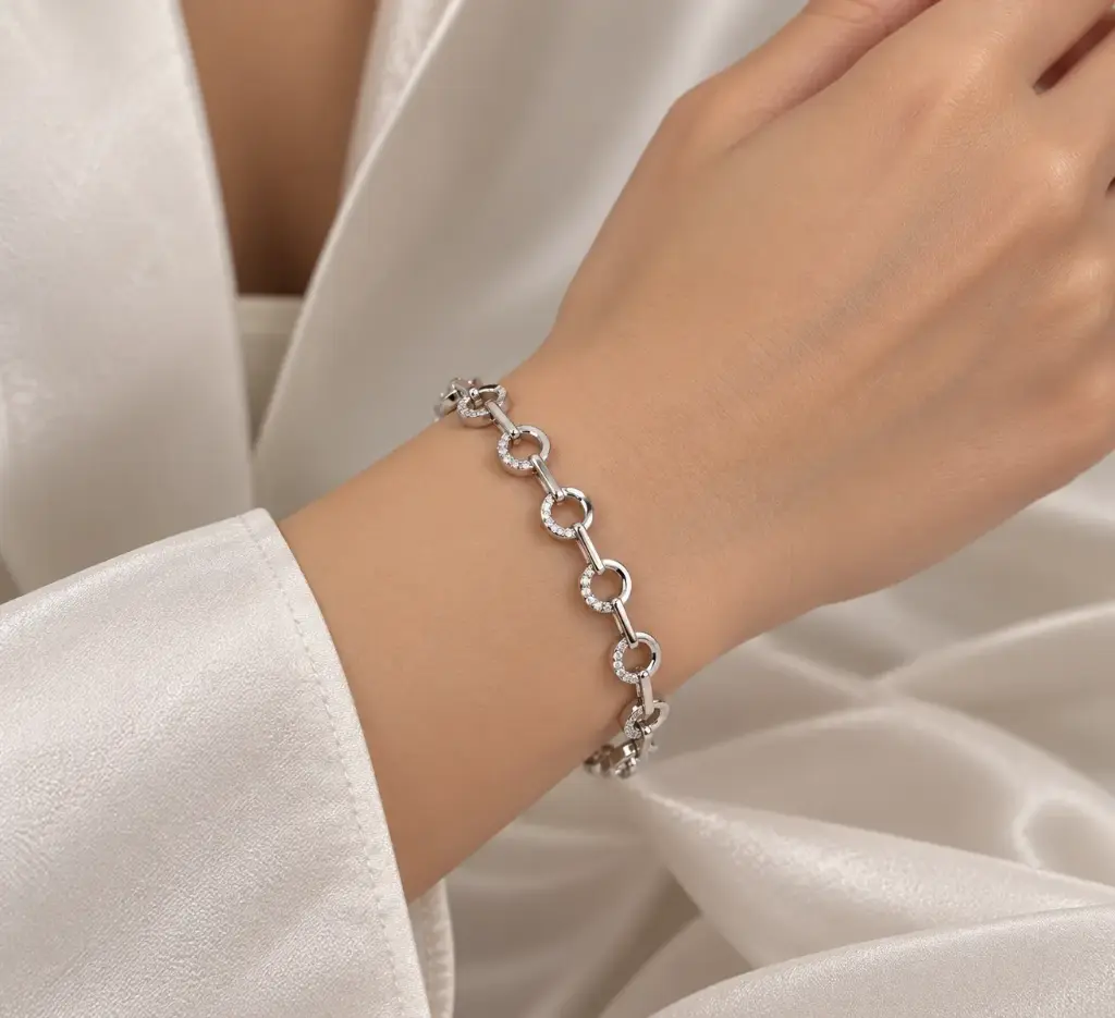 925 sterling silver bracelet with circular links partially set with white stones.