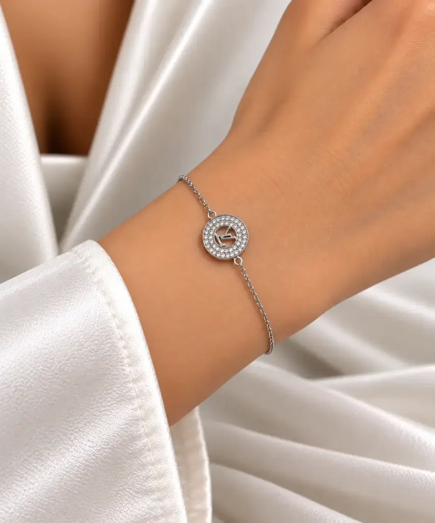 925 sterling silver bracelet with a white stone-set circular design and LV lettering at the center. 