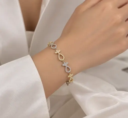 [BRC-002] Gold and silver-tone bracelet with white stone-set teardrop links.